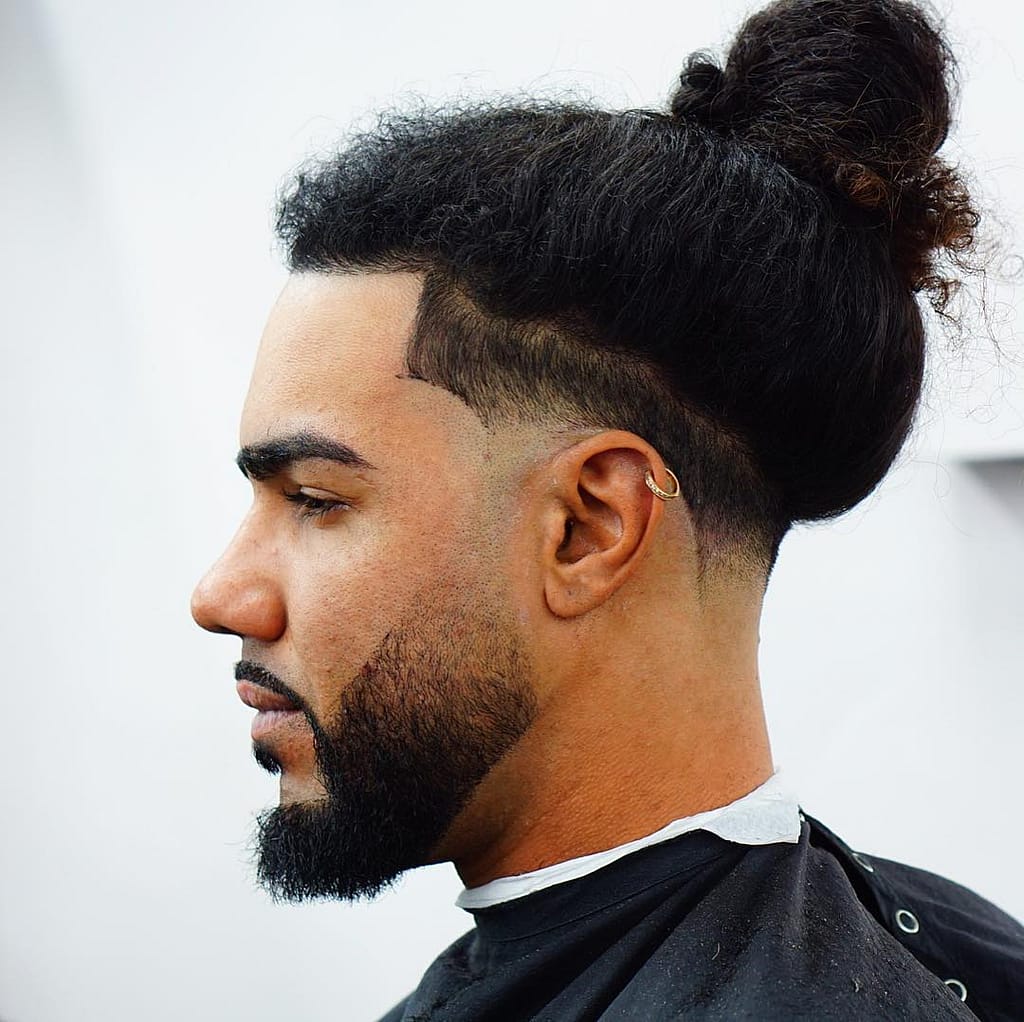 Curly Hair + Man Bun Hairstyle + Low Fade